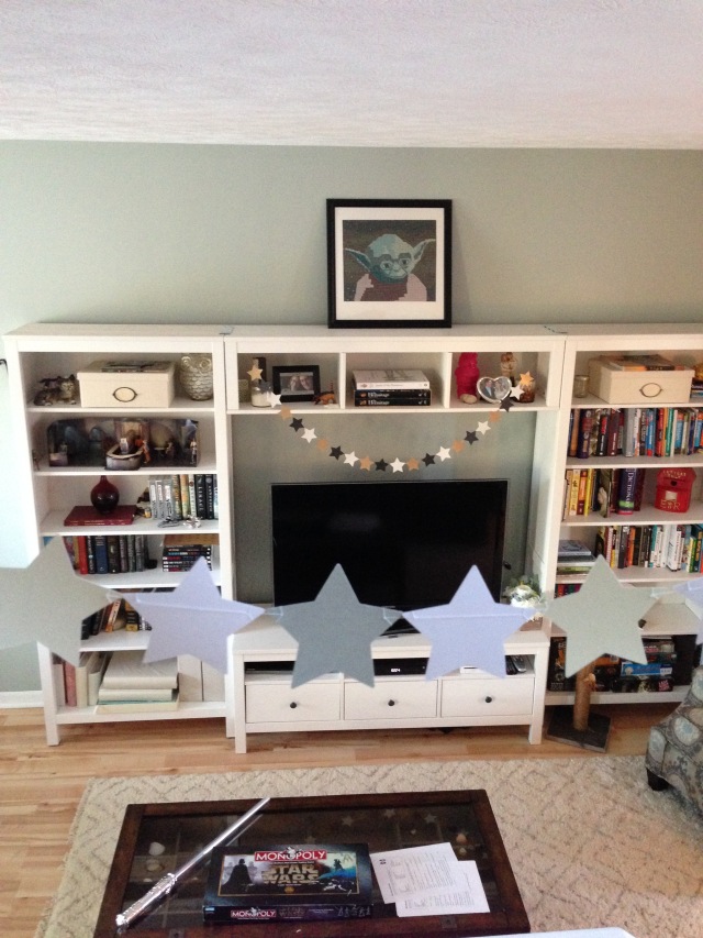 Star garlands and Yoda portrait in the living room.